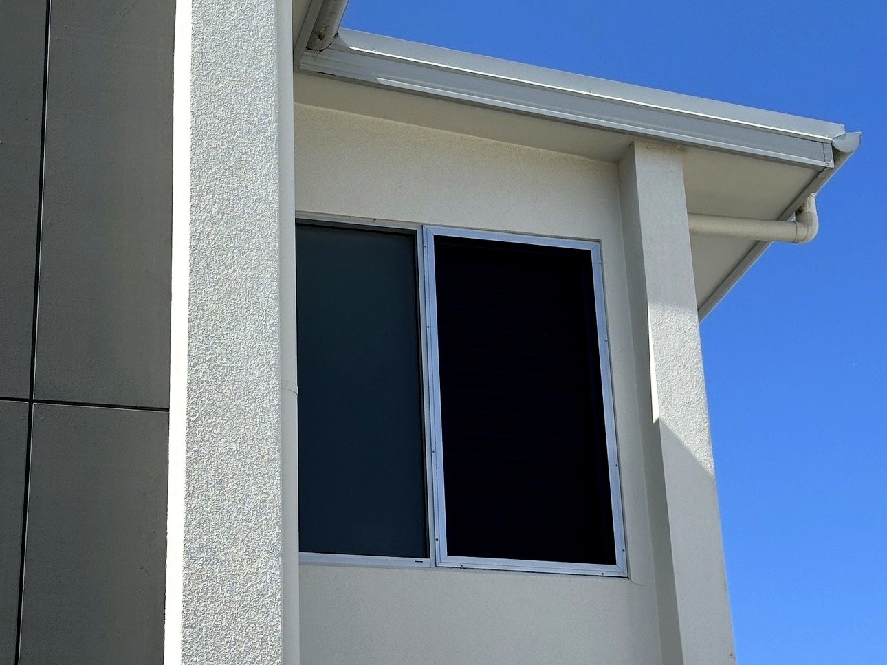 Soft-wash house washing — render before and after — after restoration